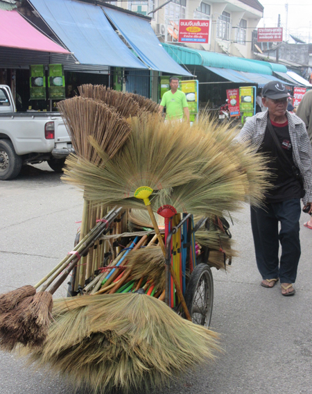 Brooms for sale by vendor with a cart, Thailand