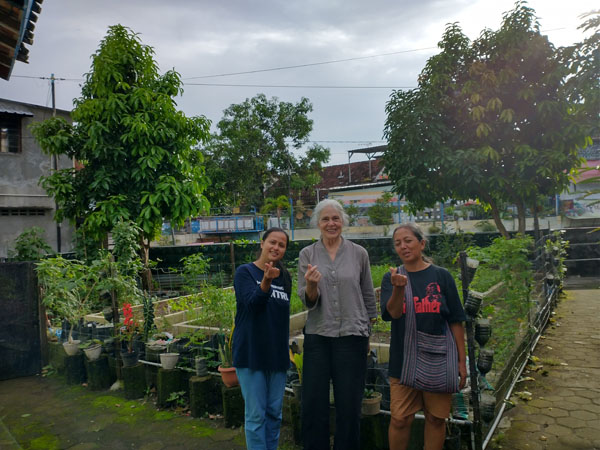 the brains behind the community garden we are pictured in. Many crops are grown vertically since space is at a premium.