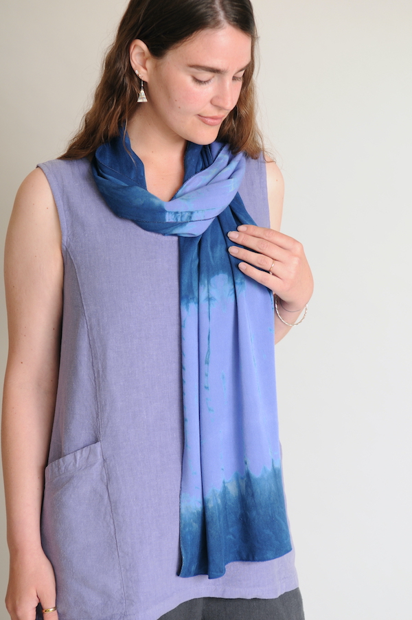 Hand dipped in shades of Indigo blue and lavender, Hannah models a scarf of soft Tencel fabric and wears a Periwinkle Trapeze Tunic.