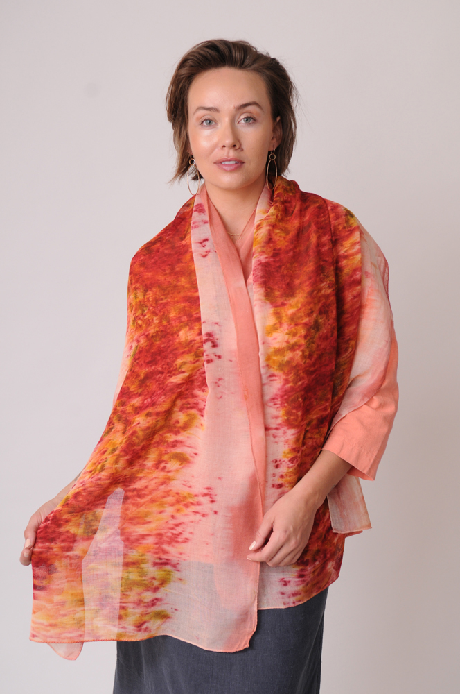 The delicately woven organically dyed wool scarf gets its sunset colors from tree bark and marigolds. 